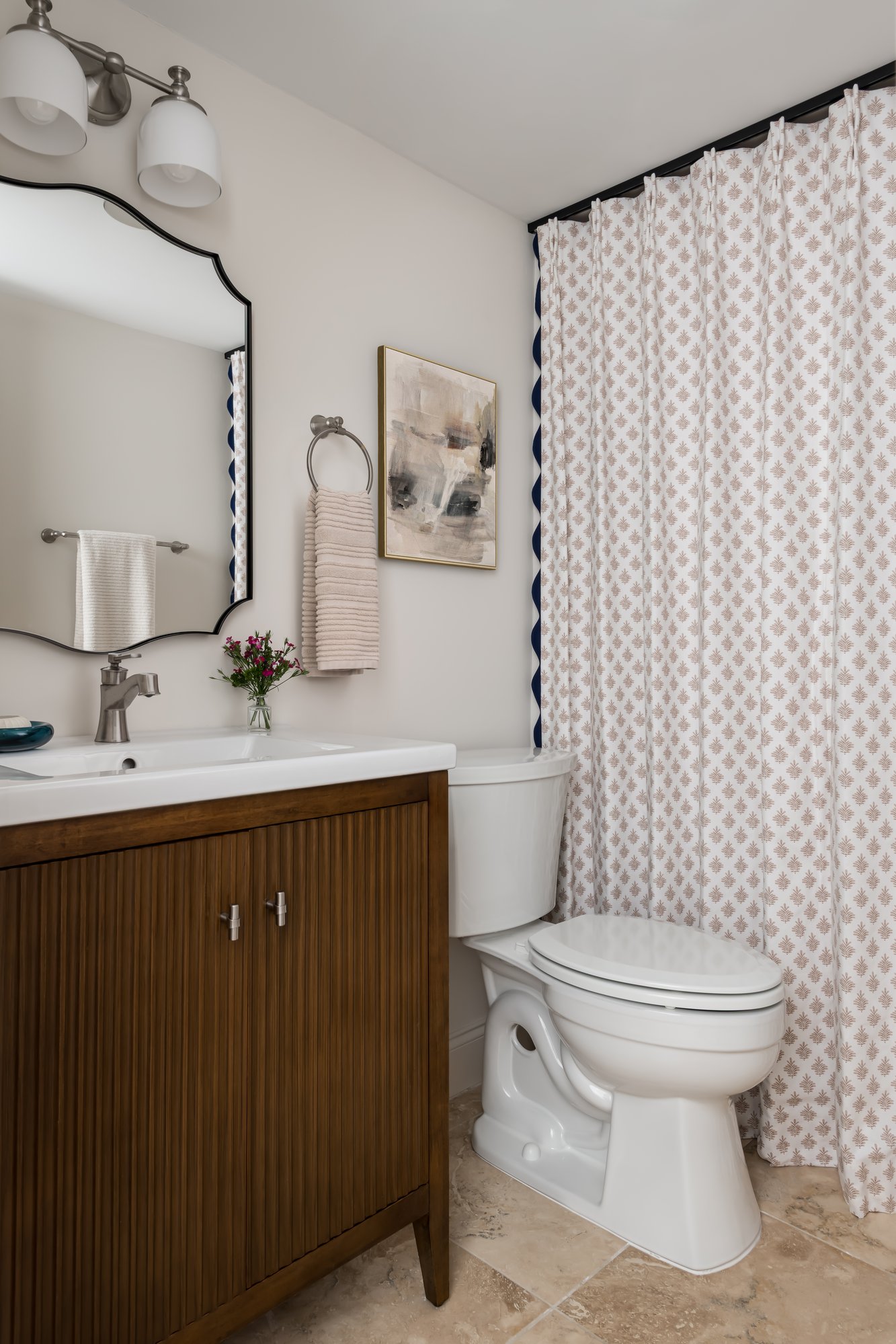 Image of a remodeled bathroom with a wooden vanity with a porcelain top.