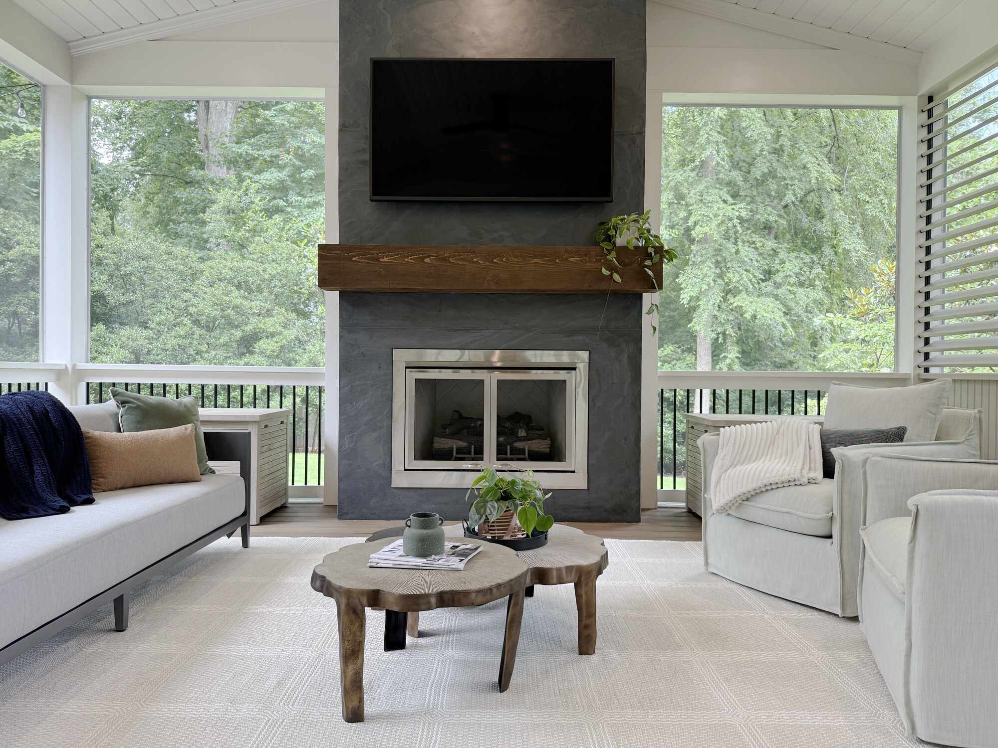 Bright and airy living space with natural wood accents by Exodus Design Build in Norcross, GA.