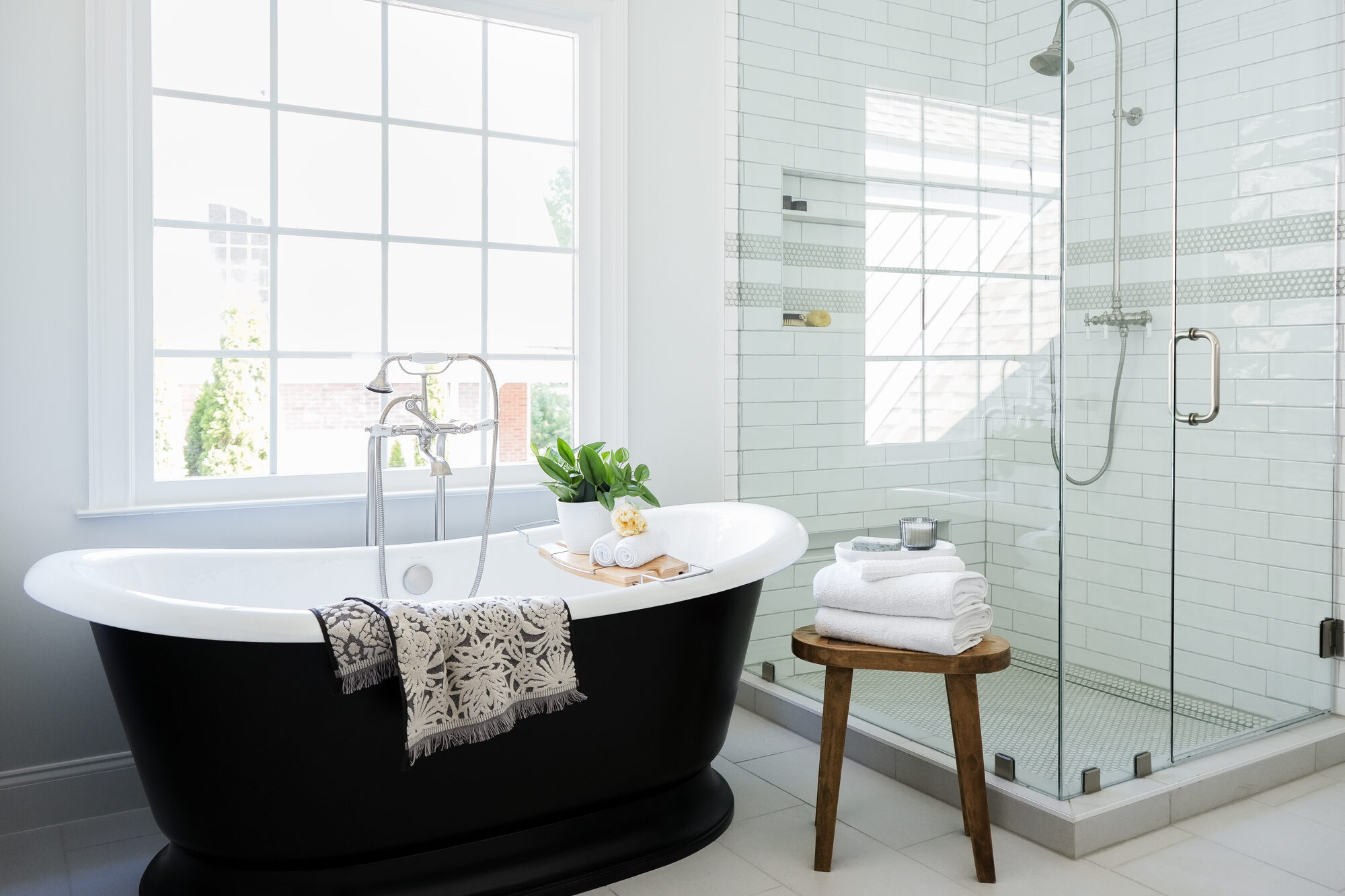Luxury bathroom with a black soaking tub and glass-enclosed shower in a custom home by Exodus Design Build serving North Metro Georgia.