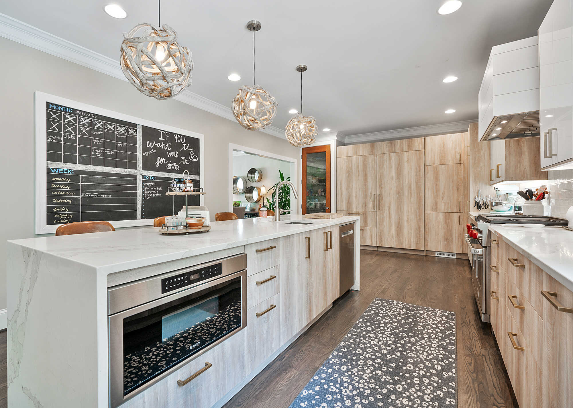 Modern kitchen island with chalkboard wall in a Flowery Branch, GA custom home by Exodus Design Build.