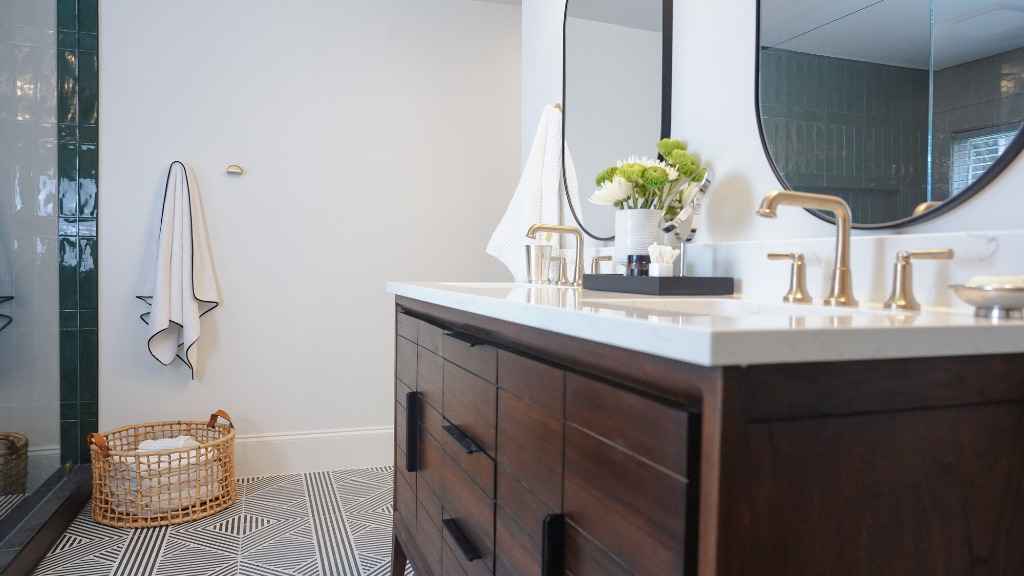 Wide shot of bathroom featuring dark wood vanity and geometric tile floors by Exodus Design Build in North Metro, GA. Wide shot of bathroom featuring dark wood vanity and geometric tile floors by Exodus Design Build in North Metro, GA.
