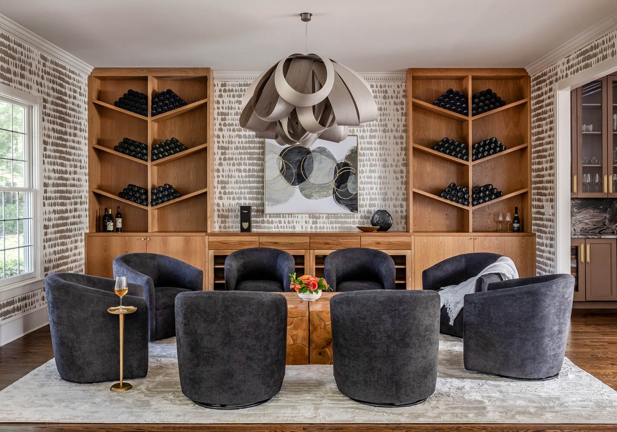 Bold custom-designed wine room with built-ins and artistic lighting by Exodus Design Build in North Metro, GA.