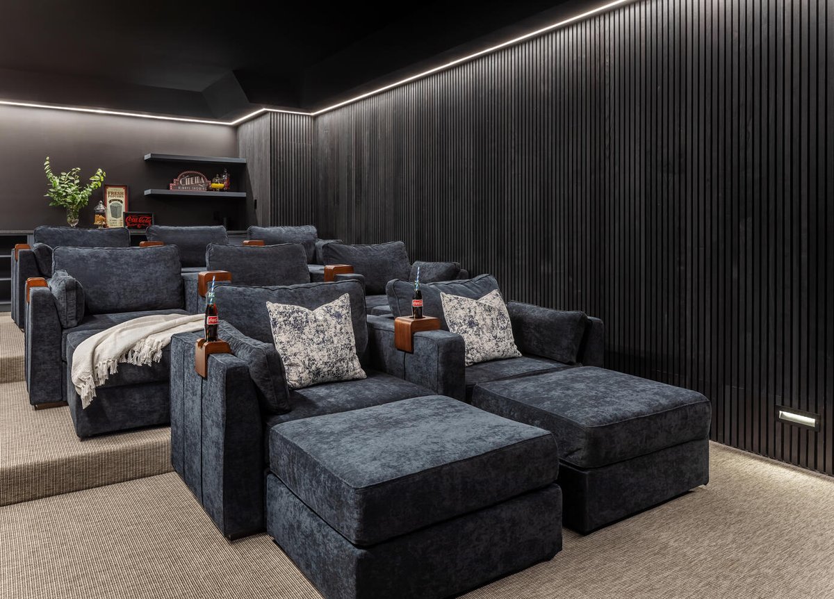 Luxury home theater with tiered seating and custom lighting by Exodus Design Build in Atlanta, GA.