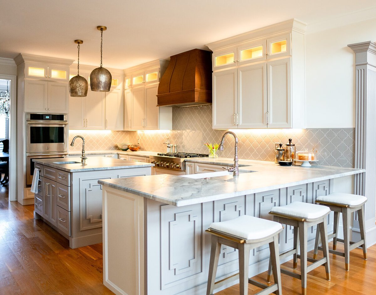 Bright traditional-style kitchen with pendant lighting and bar seating by Exodus Design Build in Buford, GA