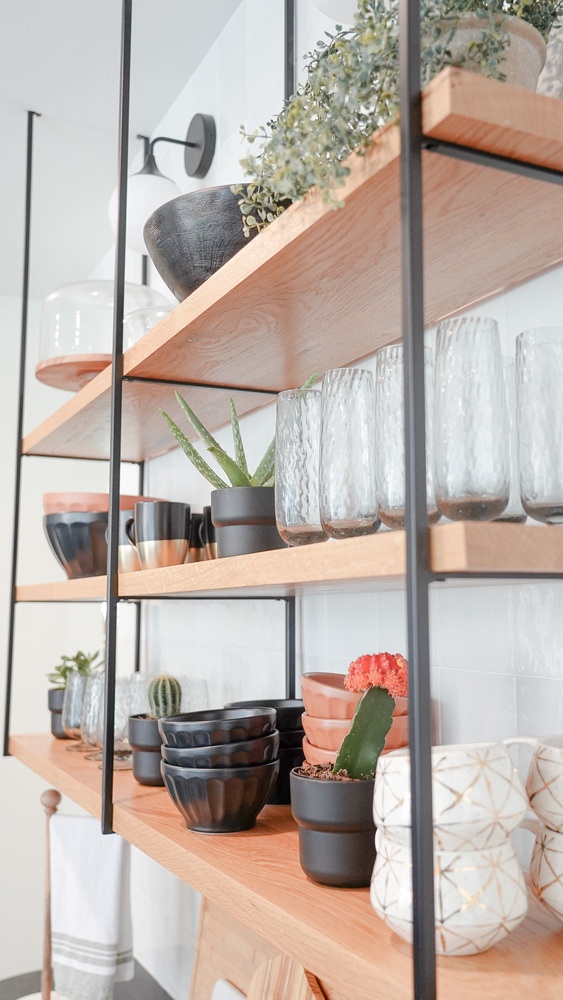 Angled view of modern kitchen shelving and plants in a Loganville, GA custom home by Exodus Design Build.