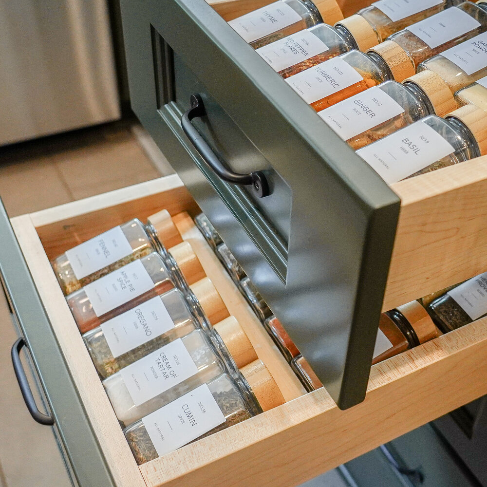 Built-in spice drawer organization in a modern custom kitchen by Exodus Design Build in Snellville, GA.