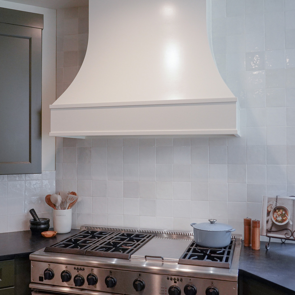 Custom vent hood and cooktop with tile backsplash in an Atlanta, GA home by Exodus Design Build.