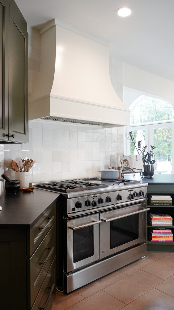 Kitchen corner with large stainless oven and cookbook stand in a Gainesville, GA custom home by Exodus Design Build.