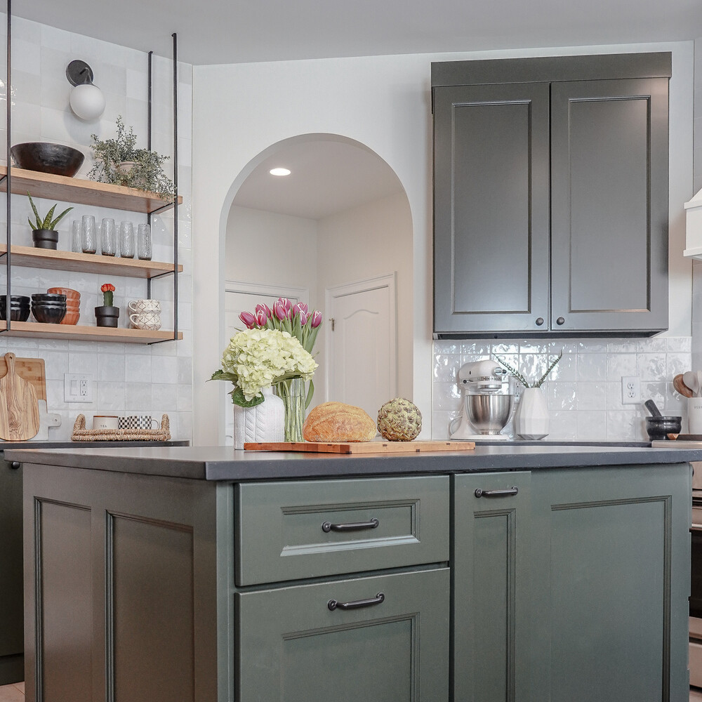 Kitchen island with green cabinetry and fresh produce in a Flowery Branch, GA custom home by Exodus Design Build.