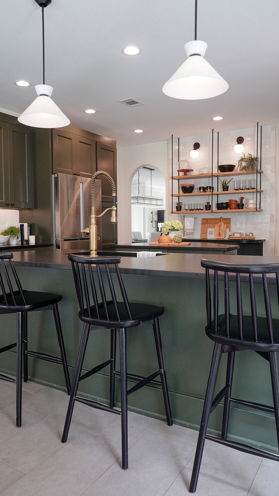 Kitchen peninsula with bar seating and brass faucet in a custom home by Exodus Design Build in Tucker, GA.