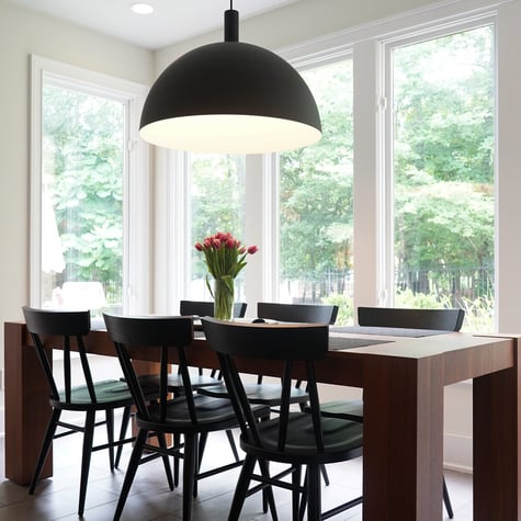 Modern dining area with tulips and large windows in a custom home by Exodus Design Build in Decatur, GA.