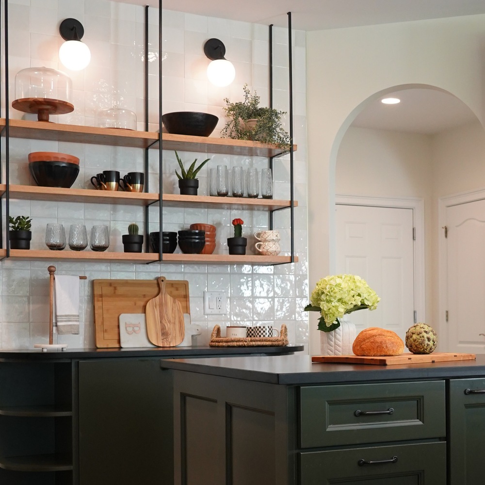 Modern green kitchen cabinets and styled open shelving in this Exodus Design Build custom home in Lawrenceville, GA.