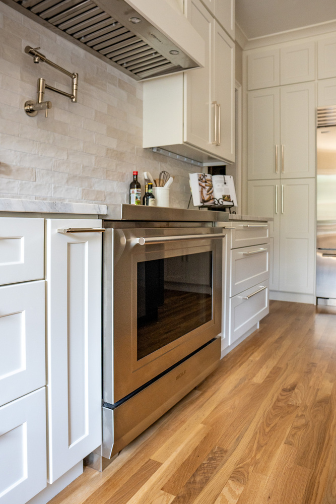 Side view of oven and base cabinets in elegant kitchen by Exodus Design Build in Stone Mountain, GA