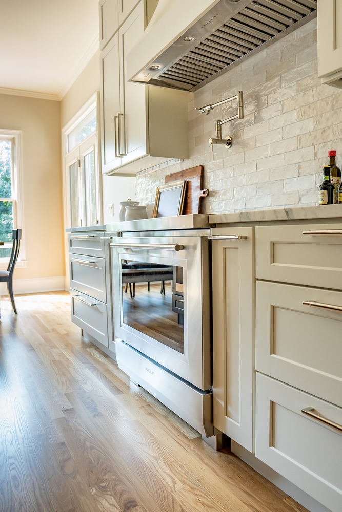 Stainless Wolf oven and white custom cabinetry in kitchen by Exodus Design Build in Gainesville, GA