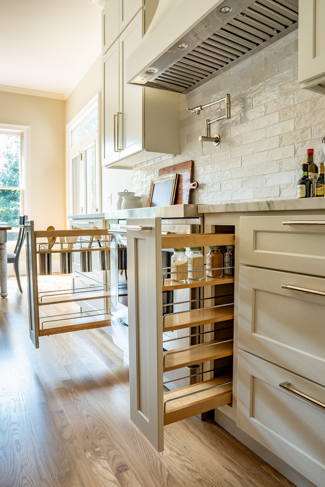 Wide angle view of kitchen storage solutions and cooktop wall by Exodus Design Build in Hoschton, GA