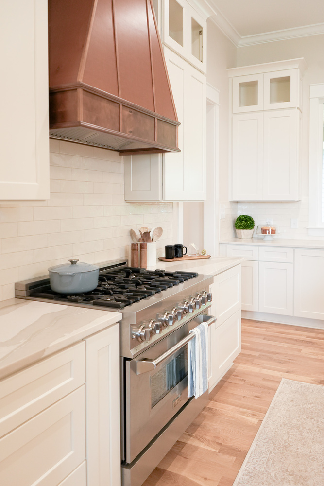 Custom kitchen cook area with stainless steel oven and wood accents by Exodus Design Build in Loganville, GA