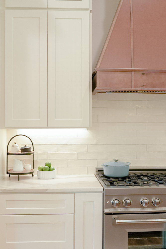 Kitchen vignette with floating shelf and decorative limes under cabinetry lighting by Exodus Design Build in Berkeley Lake, GA