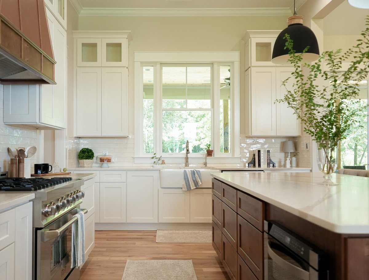 Natural light pouring over apron sink and quartz counters in a custom kitchen by Exodus Design Build in Peachtree Corners, GA