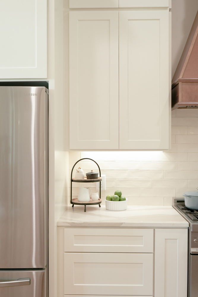 Simple and elegant countertop setup beside stainless fridge by Exodus Design Build in Tucker, GA