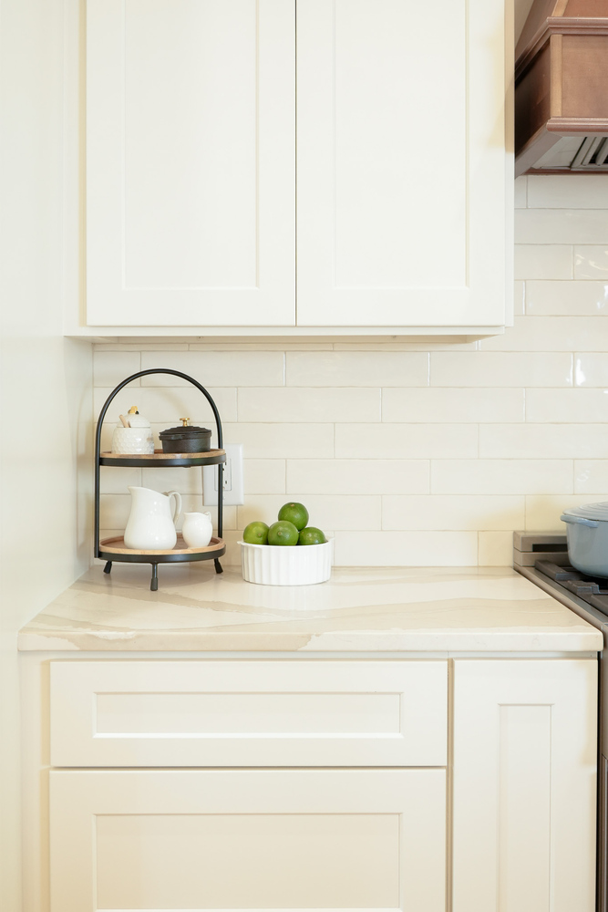 White cabinetry corner with farmhouse-style decor and natural elements by Exodus Design Build in Atlanta, GA