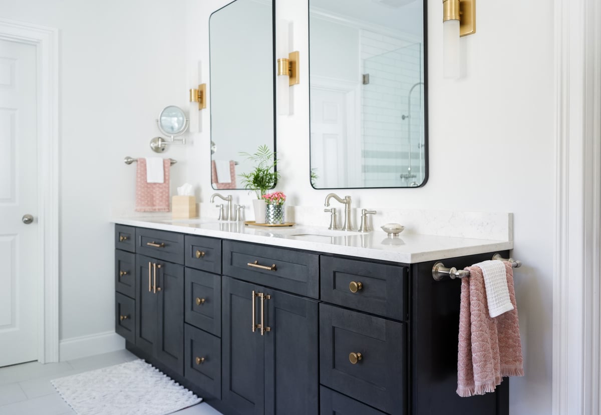 Custom double vanity with dark cabinets and modern fixtures in a custom home by Exodus Design Build in Duluth, GA.