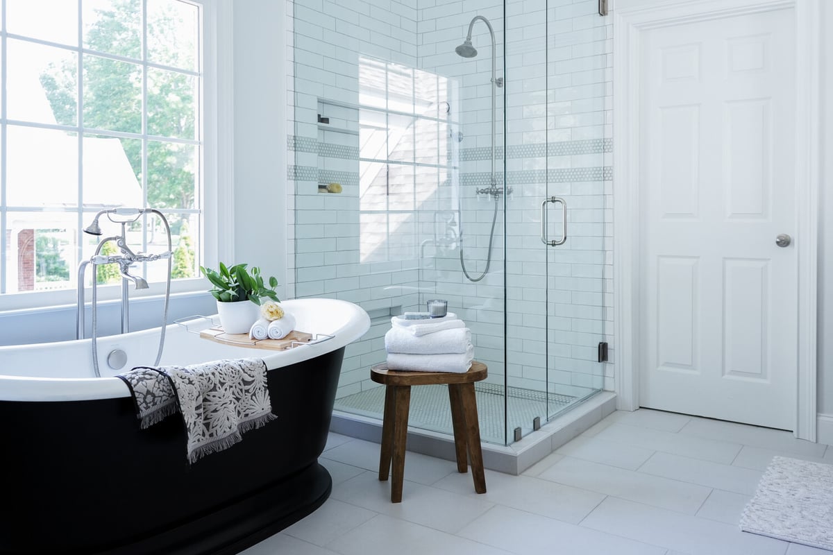 Freestanding tub and glass shower in a custom home bathroom designed by Exodus Design Build in Lawrenceville, GA.