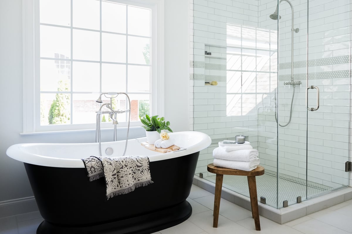 Luxury bathroom with a black soaking tub and glass-enclosed shower in a custom home by Exodus Design Build serving North Metro Georgia.