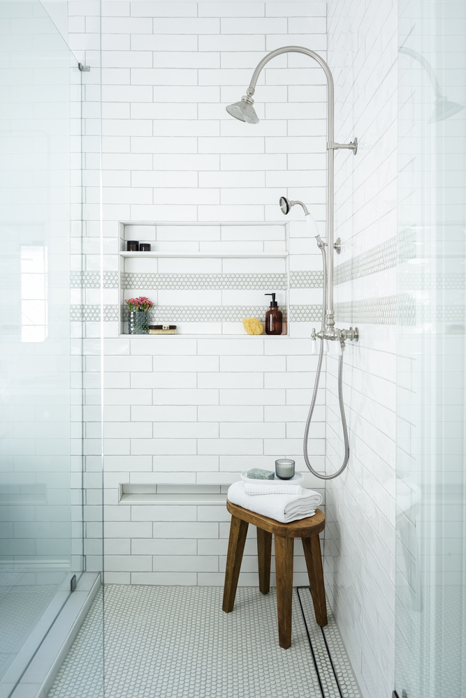 Spa-inspired walk-in shower with bench seating and tile accents by Exodus Design Build in Auburn, GA.