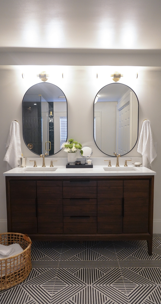 Bathroom vanity with dual sinks and floral accents in a custom home by Exodus Design Build in Stone Mountain, GA.