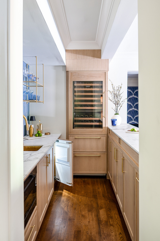 Custom kitchen bar with extended drawer storage and wood flooring in Oakwood, GA by Exodus Design Build