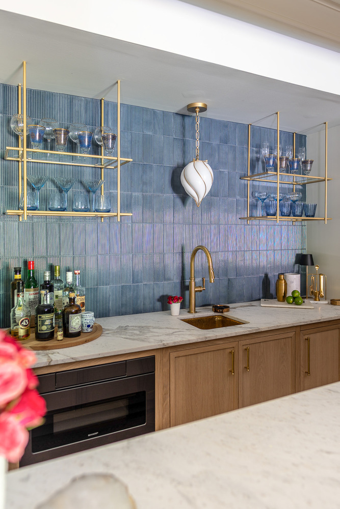 Detail of custom bar countertop with cocktail accessories and tile backsplash in Lawrenceville, GA by Exodus Design Build