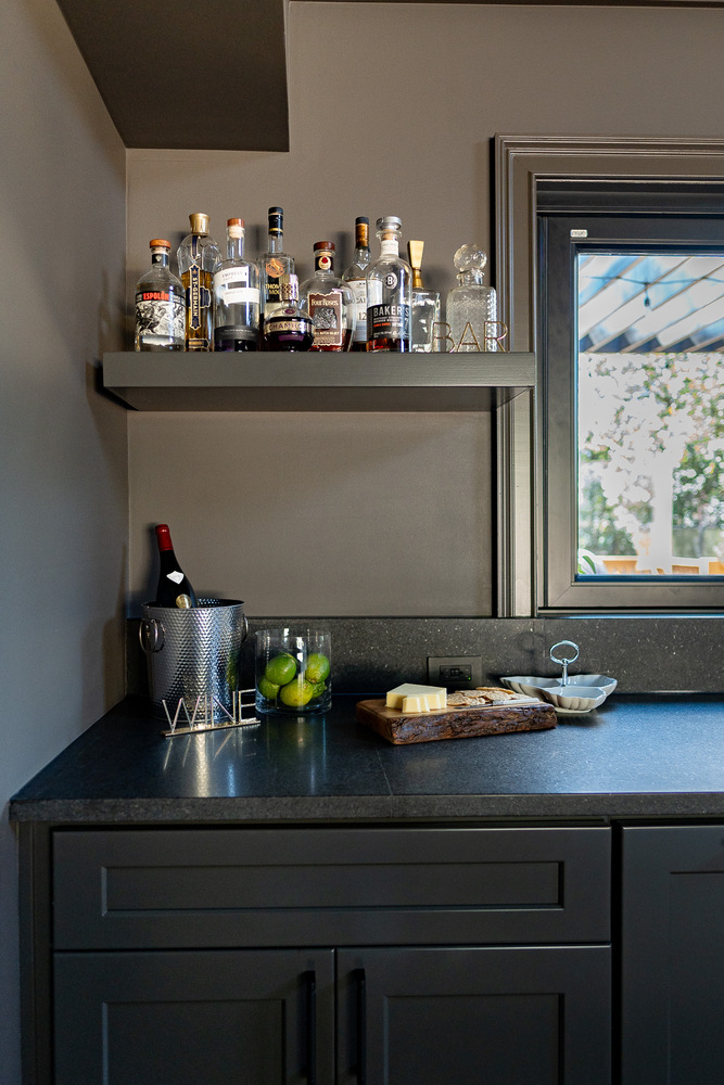 Custom home bar station with open shelving and fresh limes by Exodus Design Build in Gainesville, GA