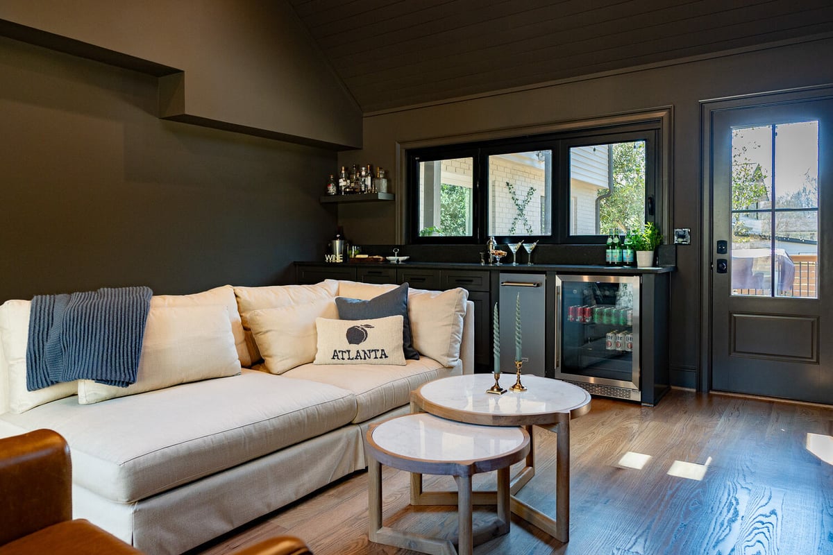 Full view of living room bar with white sofa and built-in drink station by Exodus Design Build in Atlanta, GA