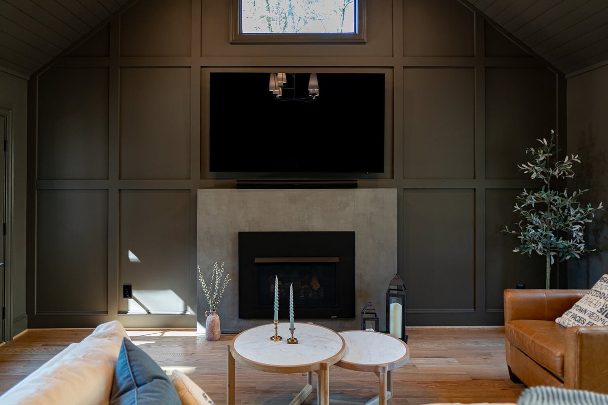 Living room with modern fireplace and mounted TV in custom home by Exodus Design Build in Gainesville, GA