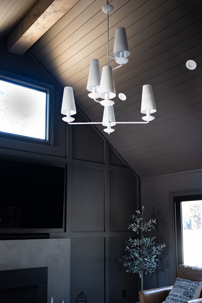 Vaulted ceiling with white modern chandelier in custom living room by Exodus Design Build in Oakwood, GA