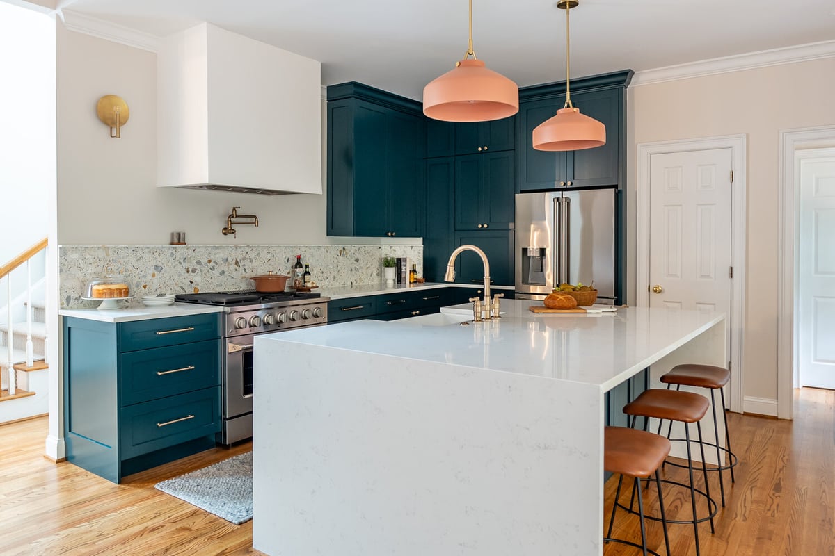 Open-concept kitchen featuring bold cabinet color and terrazzo backsplash by Exodus Design Build in Johns Creek, GA