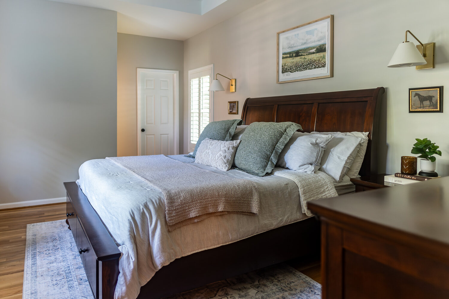 Cozy primary bedroom remodel with wood furniture and modern lighting in Suwanee, GA by Exodus Design Build. Cozy primary bedroom remodel with wood furniture and modern lighting in Suwanee, GA by Exodus Design Build.