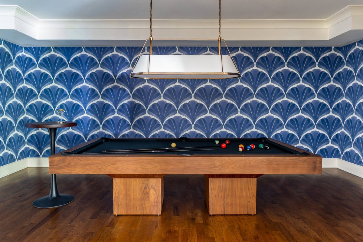 Modern game room with pool table and bold blue fan-pattern wallpaper by Exodus Design Build in Peachtree Corners, GA.