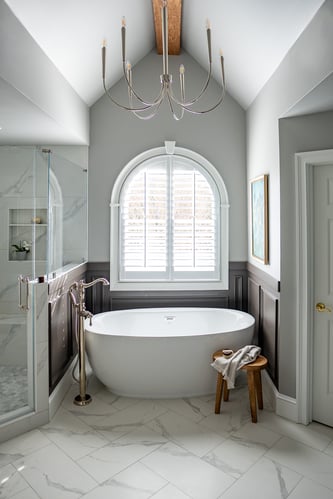 Soaking tub centerpiece with chandelier and natural light in custom home by Exodus Design Build in Atlanta, GA