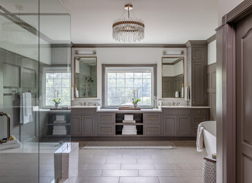 Spacious double vanity bathroom with chandelier lighting in a Fayetteville, GA custom home by Exodus Design Build