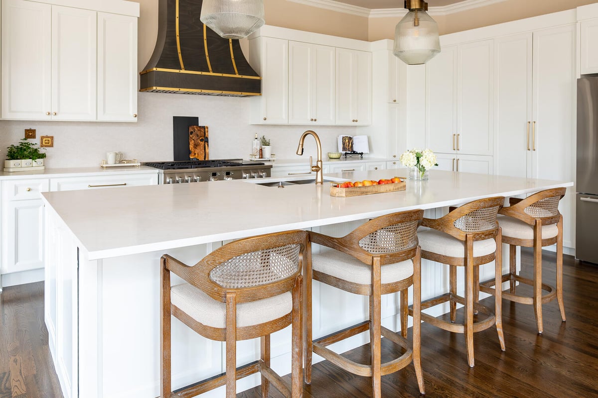 Bright white kitchen with brass fixtures and custom finishes in a Lawrenceville, GA custom home by Exodus Design Build.