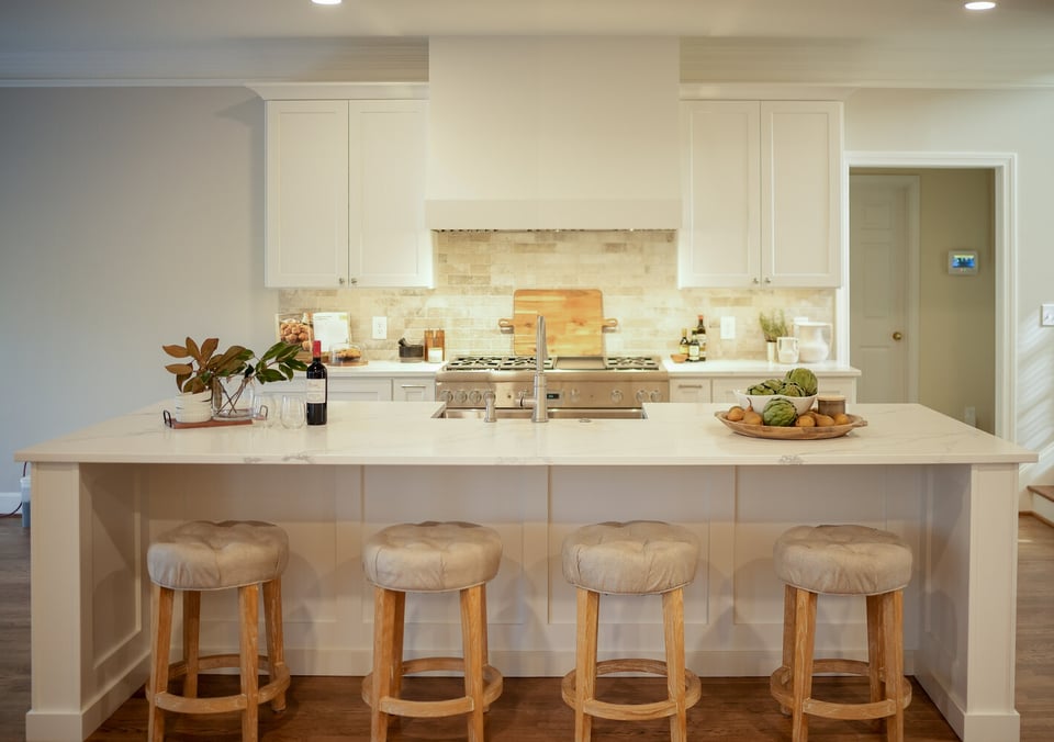Luxury white kitchen with complete cooking and dining layout by Exodus Design Build in Berkeley Lake, GA.