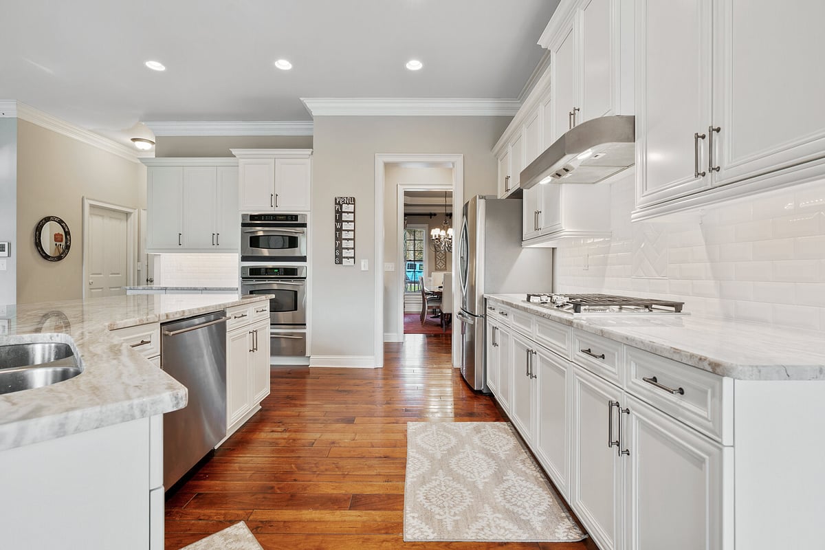 Modern kitchen design with double ovens and marble countertops in a custom-built Atlanta, GA home by Exodus Design Build.