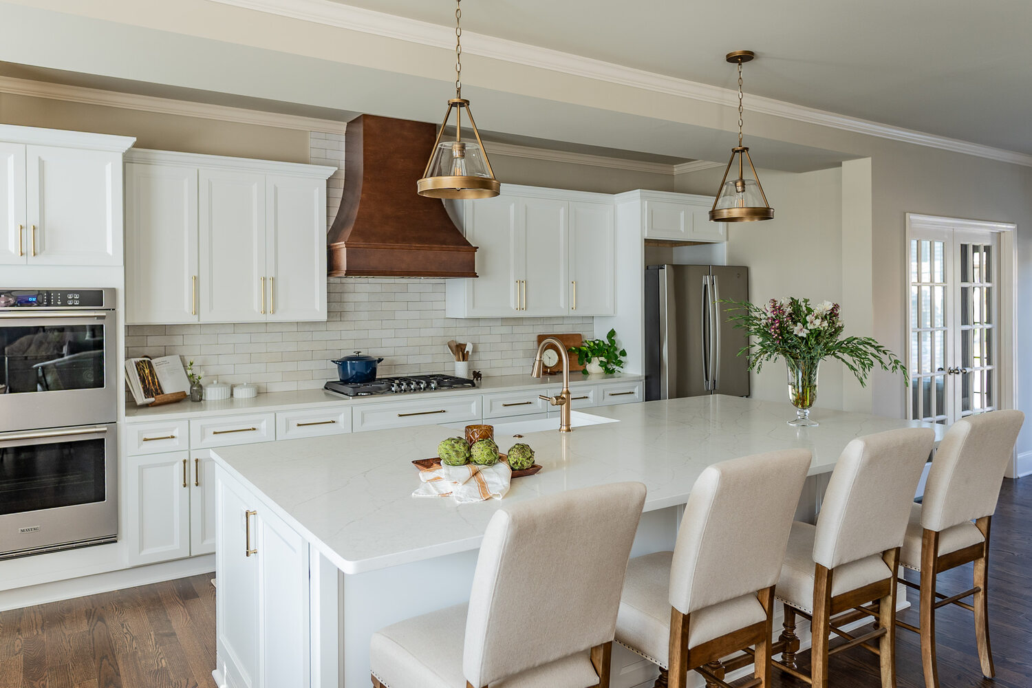 White custom kitchen with quartz island and copper accents by Exodus Design Build in Atlanta, GA.