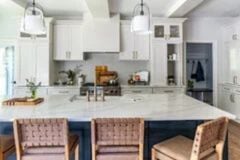 A remodeled island-centric open kitchen in the Greater Atlanta area white cabinets and white marble countertops