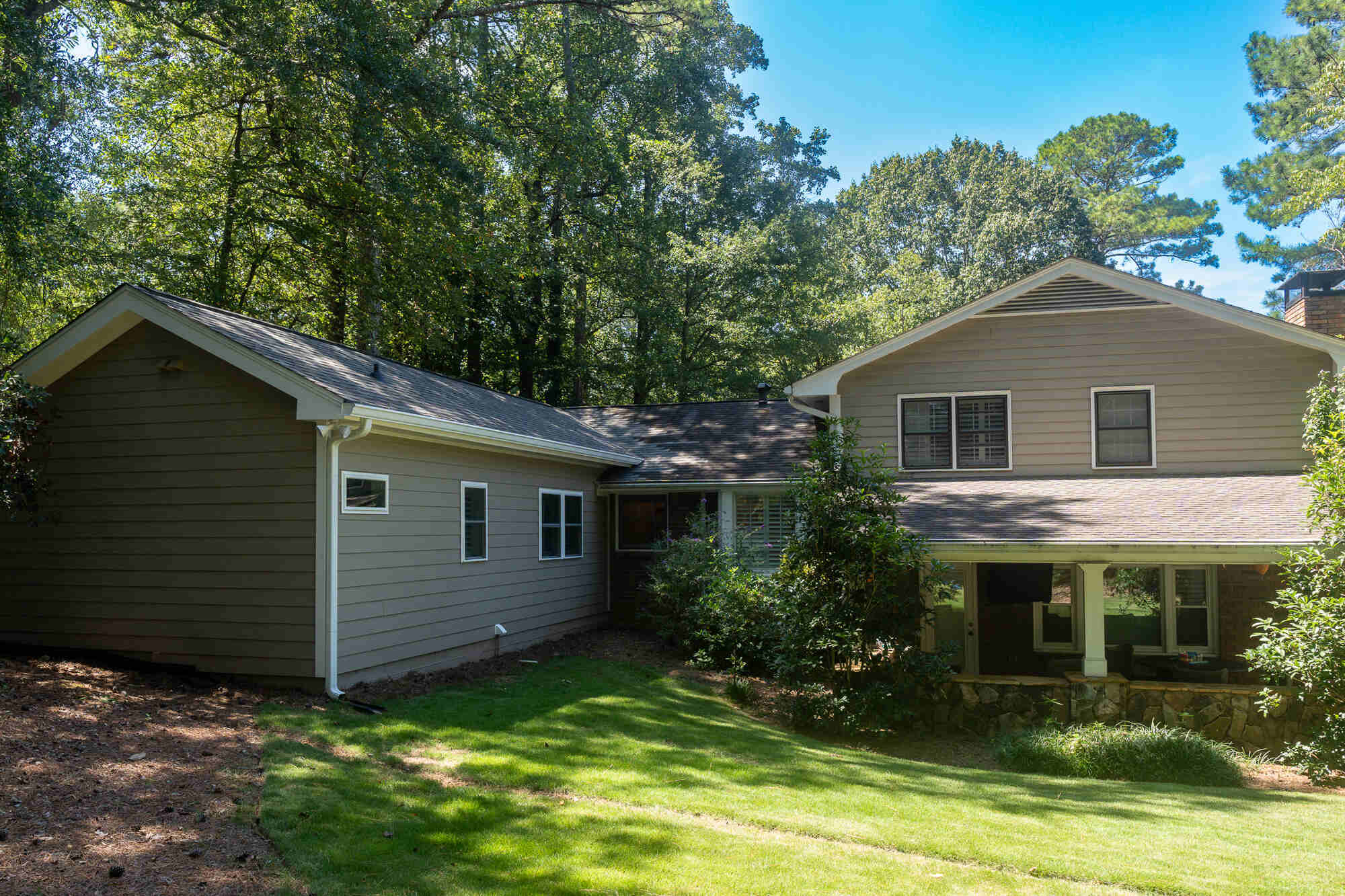Wide view of custom home addition and exterior renovation in Flowery Branch, GA by Exodus Design Build.