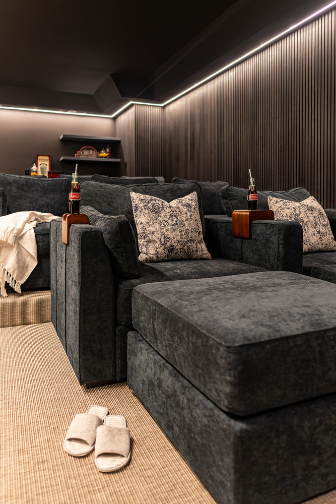 Luxurious custom home theater with reclining chairs and footrests by Exodus Design Build in Norcross, GA.