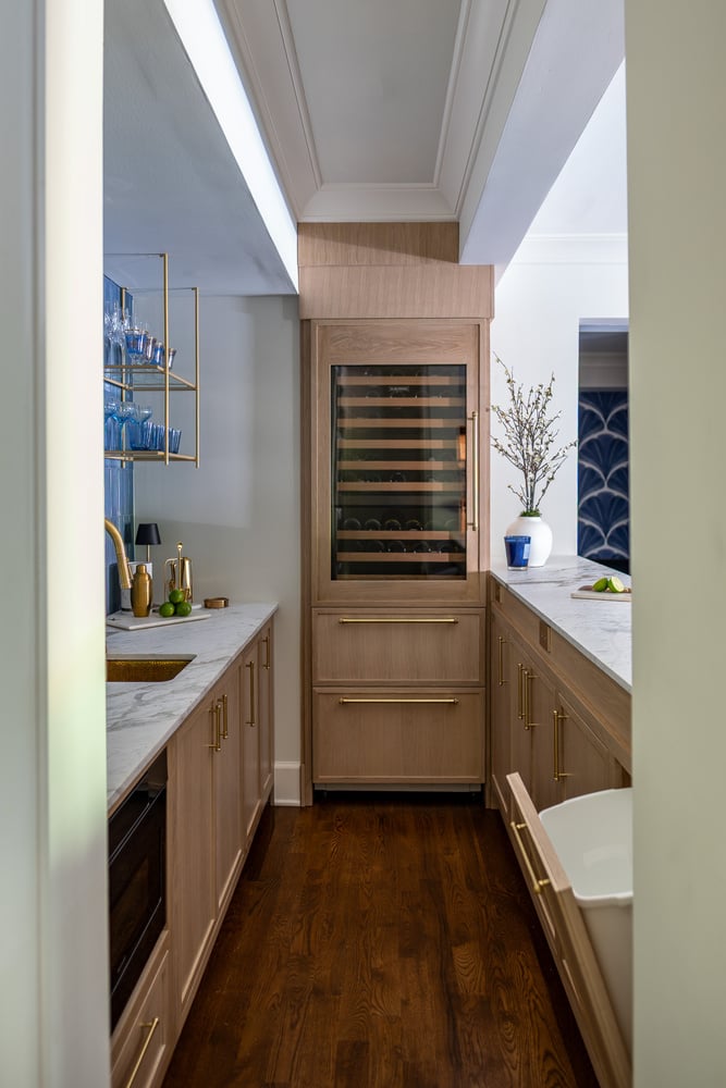 Luxury wet bar with open lower drawer storage and wine cooler by Exodus Design Build in Johns Creek, GA.