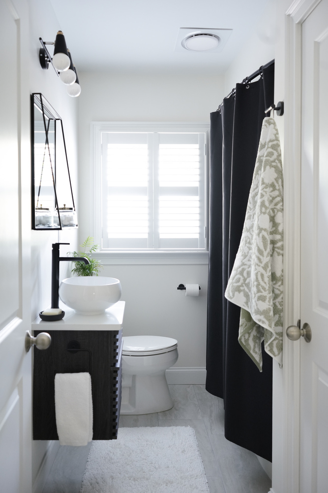 Minimalist bathroom with vessel sink and white plantation shutters by Exodus Design Build in Suwanee, GA.