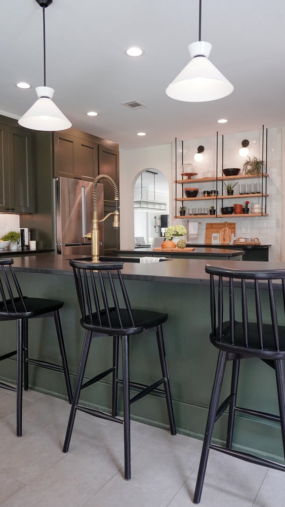 Kitchen island with black stools and overhead lighting in a Fayetteville, GA custom home by Exodus Design Build